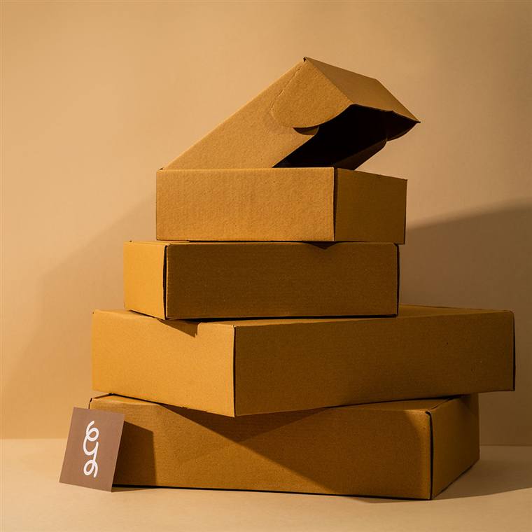 Stack of branded kraft mailer boxes ready for pickup